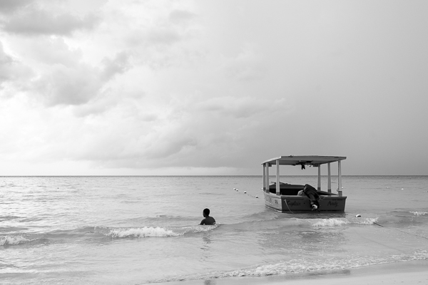 boy and boat in ocean